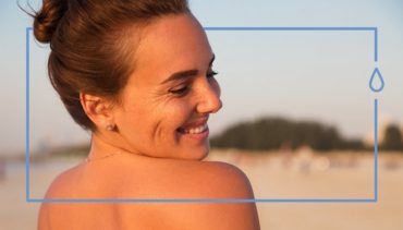 woman shows her back while smiling