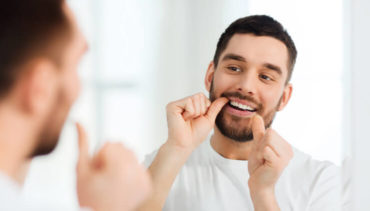 man cleaning his teeth