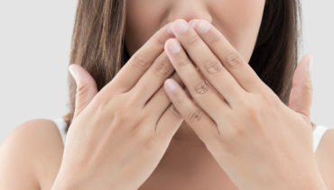 woman touching mouth