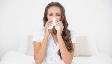 woman wipes nose