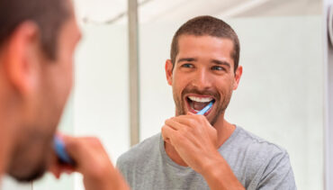 man brushing his teeth