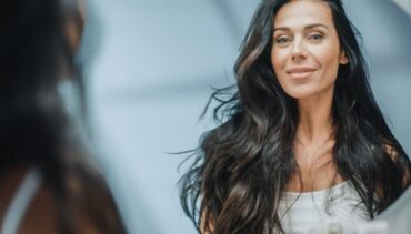 woman with long dark hair smiles