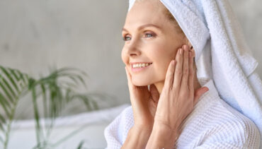 old woman with towels smiles